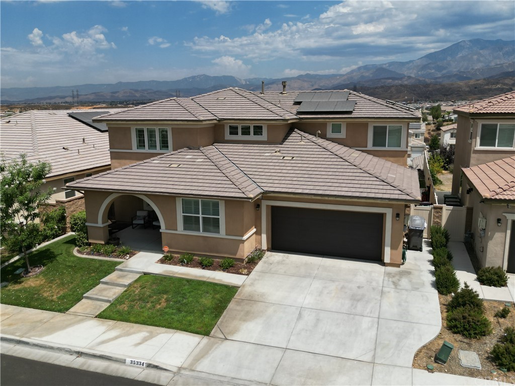 35334 Thorpe Trail Beaumont, CA 92223 - Photo 2 of 74 a front view of a house with a yard and garage