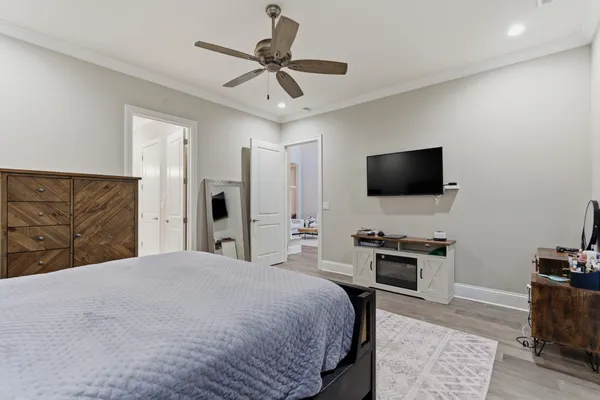 a spacious bedroom with a bed and a chandelier