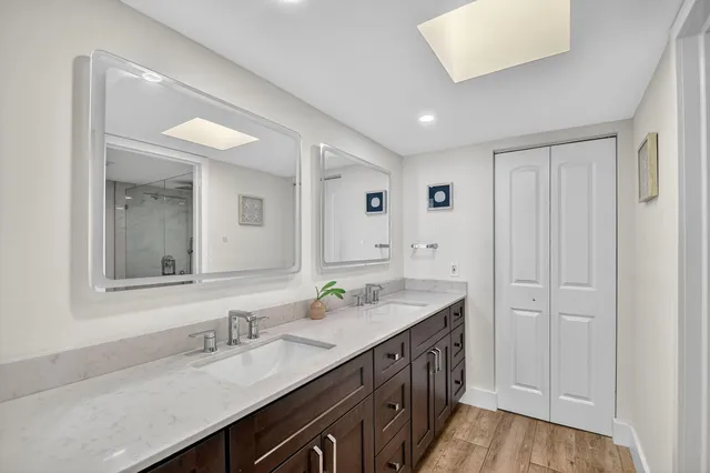 a bathroom with double sink and a mirror