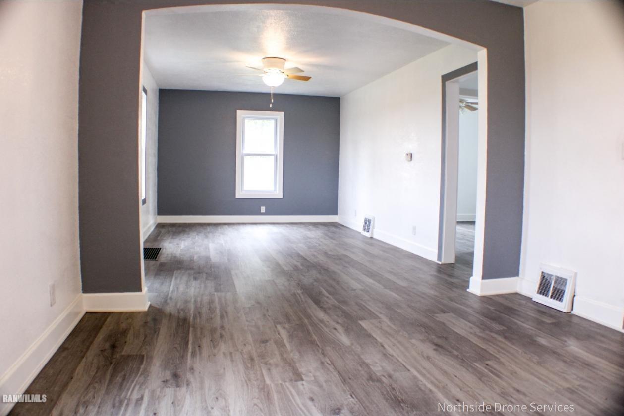 15456 West Nora Road Winslow, IL 61089 - Photo 2 of 14 an empty room with wooden floor and windows