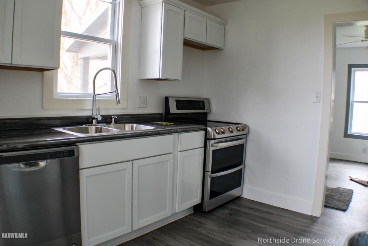 15456 West Nora Road Winslow, IL 61089 - Photo 3 of 14 a kitchen with a sink stove and cabinets