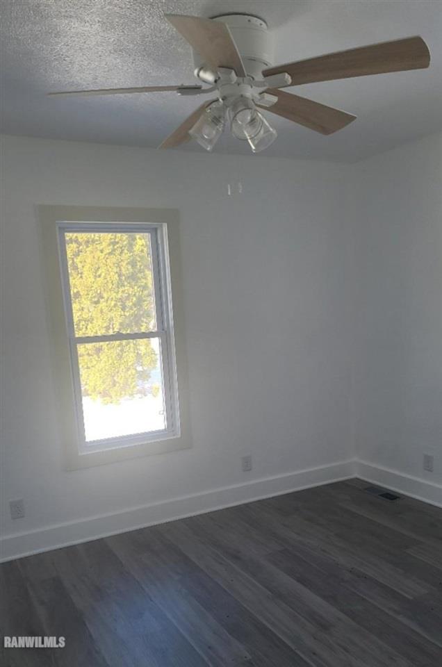 15456 West Nora Road Winslow, IL 61089 - Photo 5 of 14 an empty room with wooden floor and windows