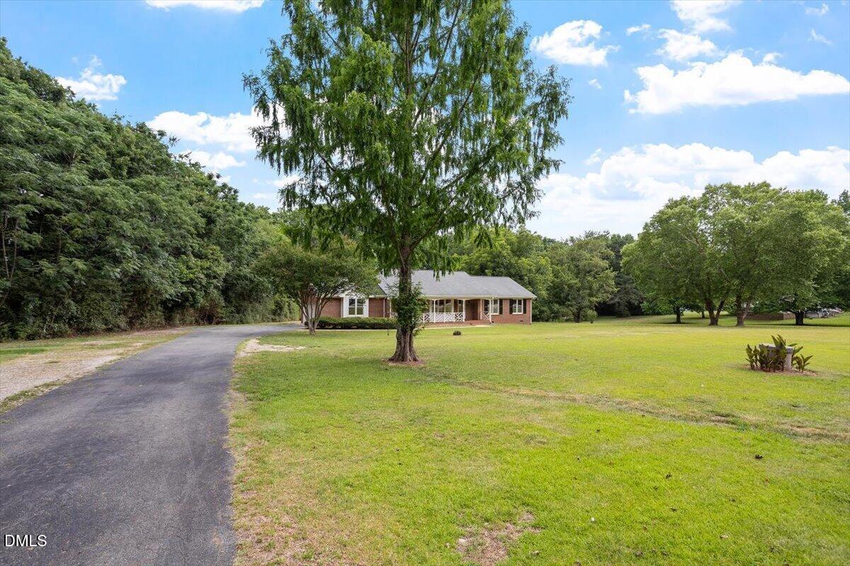 805 Rand Road Garner, NC 27529 - Photo 2 of 38 a swimming pool with trees in the background