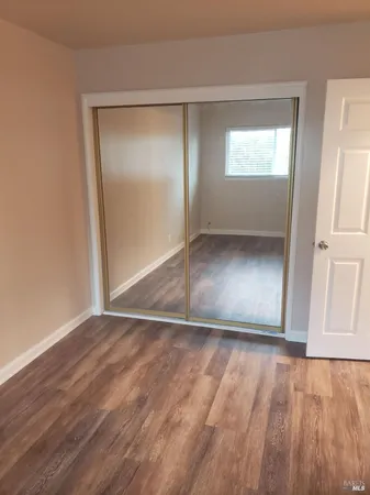 a room with granite countertop cabinets and sink