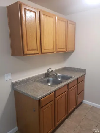 a close view of a refrigerator in kitchen and cabinets