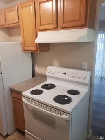 a bathroom with a sink a toilet and shower curtain
