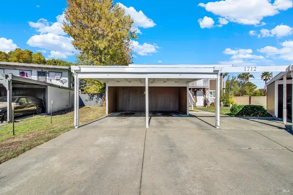 a view of a house with a garage and yard