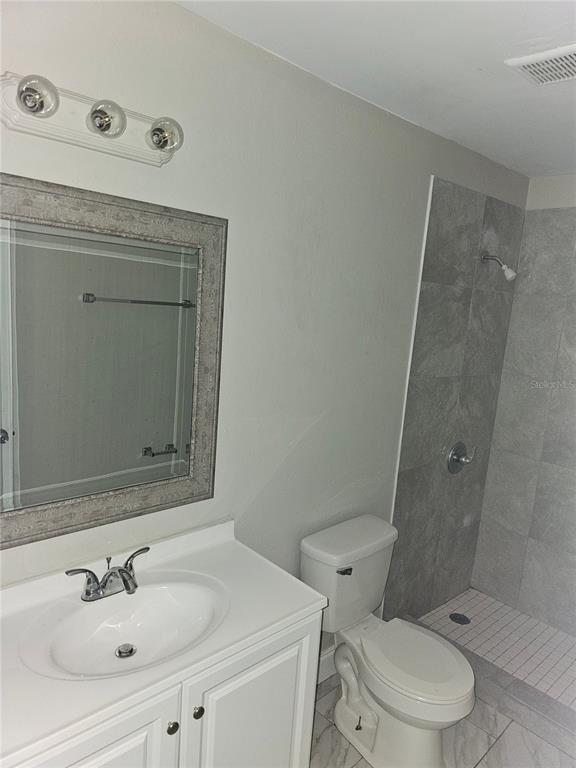 1013 Beecher Street, Unit 1 Leesburg, FL 34748 - Photo 6 of 12 a bathroom with a sink toilet and shower