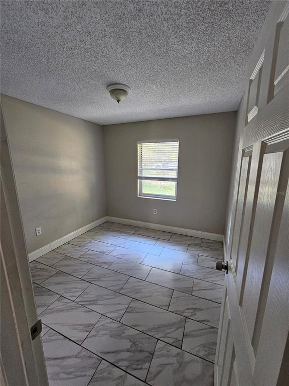 1013 Beecher Street, Unit 1 Leesburg, FL 34748 - Photo 9 of 12 a view of an empty room with a window