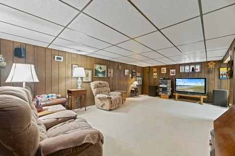 a bed room with furniture and a flat screen tv