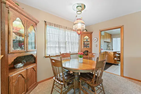 a view of a dining room with furniture wooden floor and chandelier