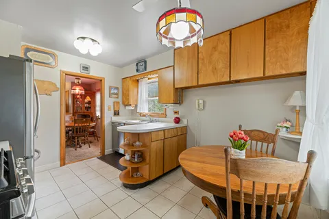 a dining room with furniture and window