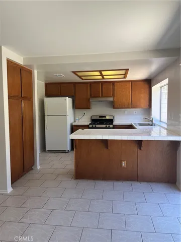 a kitchen with cabinets a sink and a stove