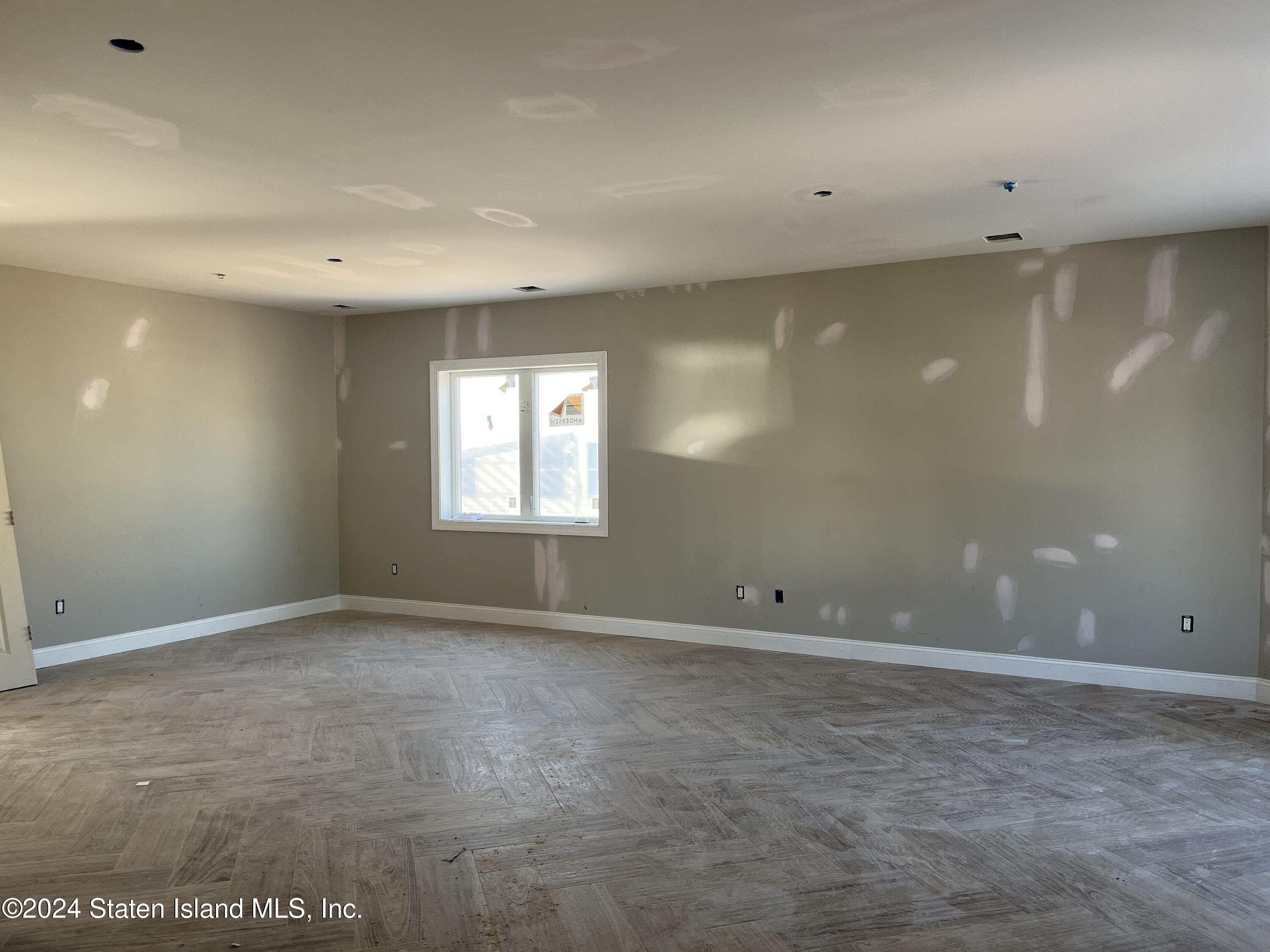 3474 Richmond Road Staten Island, NY 10306 - Photo 4 of 9 an empty room with windows