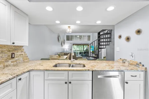 a kitchen with a sink and a granite counter tops
