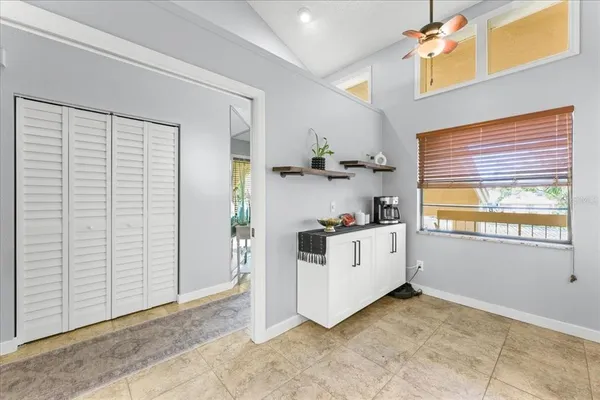 a view of kitchen with window and cabinets