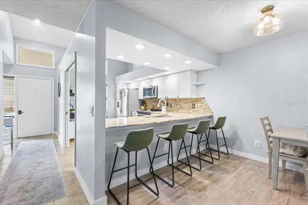 a kitchen with a table and chairs in it
