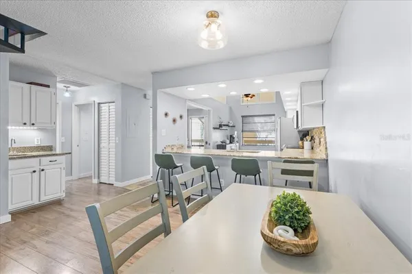 a open kitchen with white cabinets and stainless steel appliances