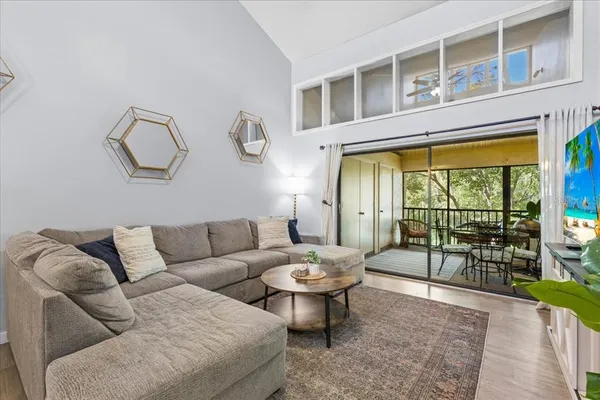 a living room with furniture and a floor to ceiling window