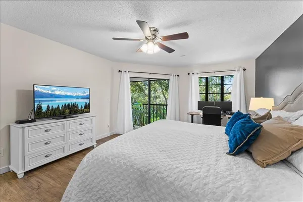 a bed room with furniture and a flat screen tv