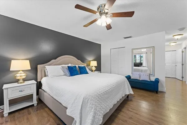 a bedroom with a bed and a chandelier