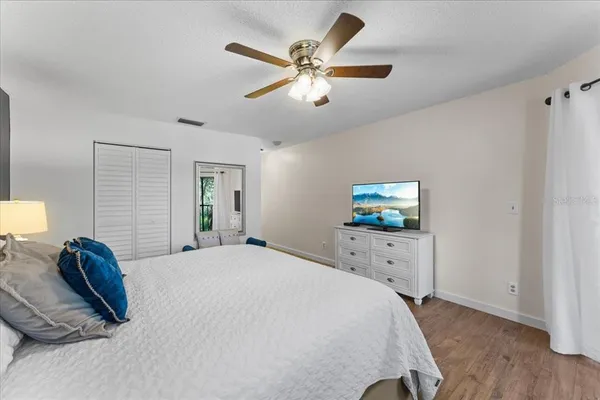 a bedroom with a bed and a flat screen tv