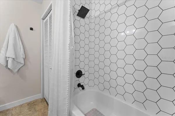 a bathroom with a white shower curtain and a sink