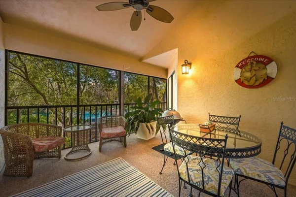 a view of a balcony with furniture and wooden floor