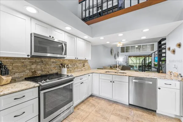 a kitchen with stainless steel appliances granite countertop a sink and cabinets