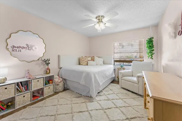 a spacious bedroom with a bed and a chandelier