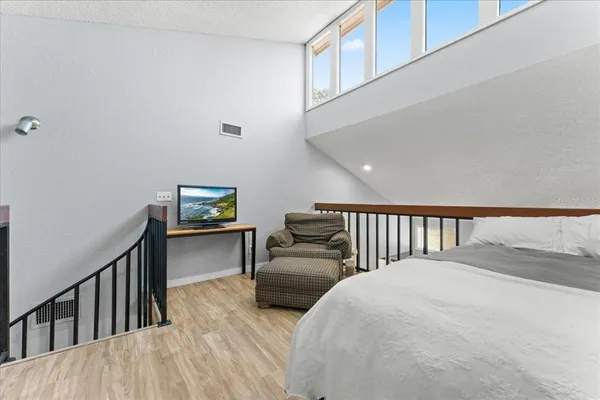 a bedroom with furniture and a window