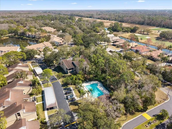 an aerial view of residential houses with outdoor space