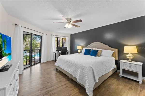 a bedroom with a large bed and a tv