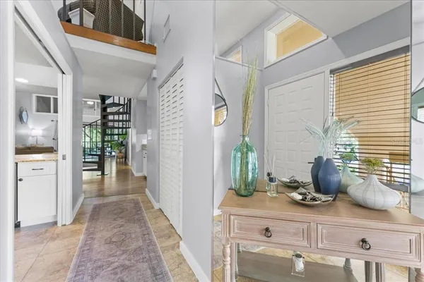 a hallway with sink and wooden floor