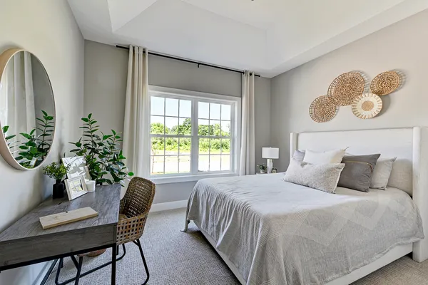 a bedroom with a bed and a chair