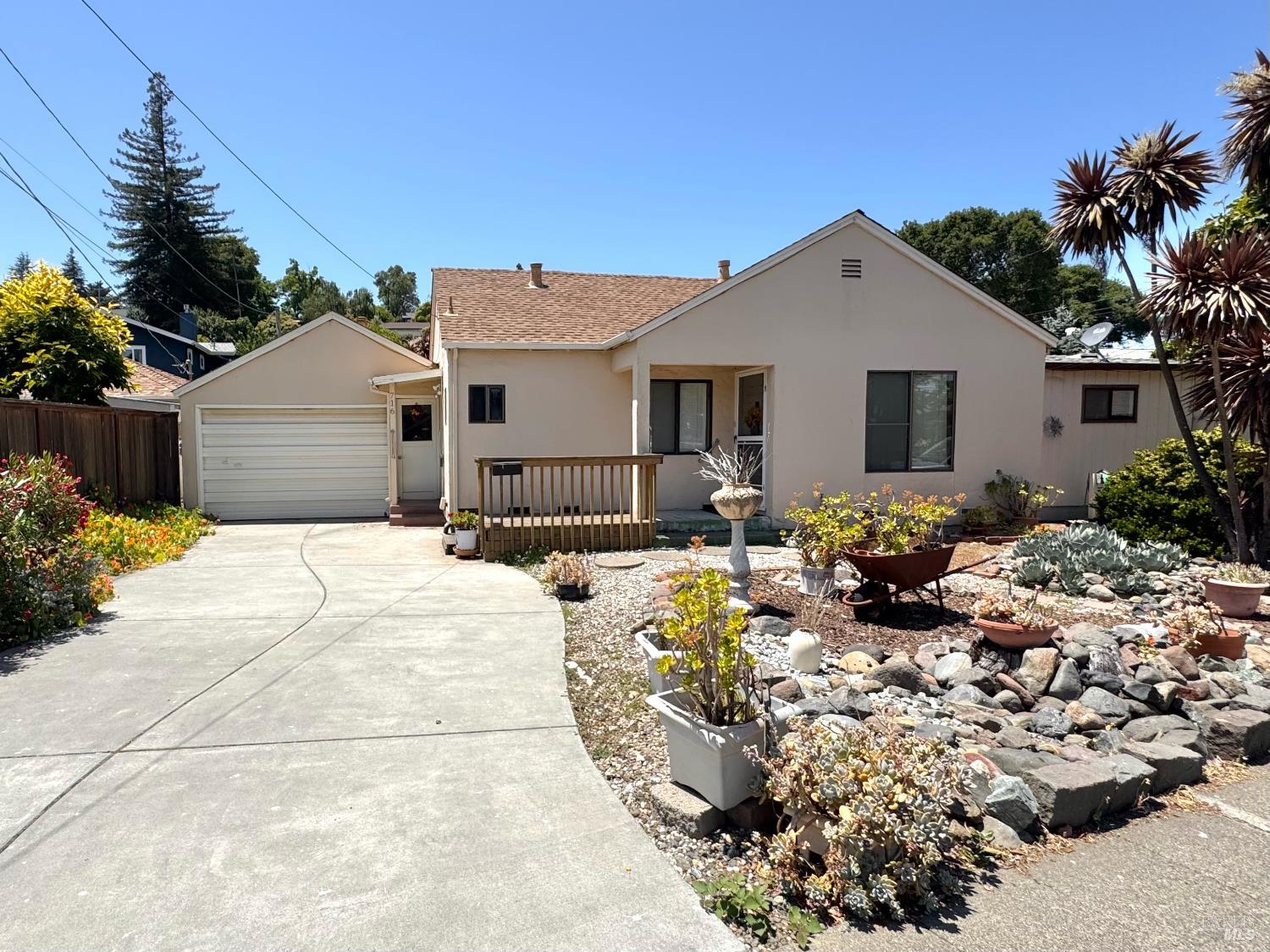 a view of a house with wooden bench in front of house