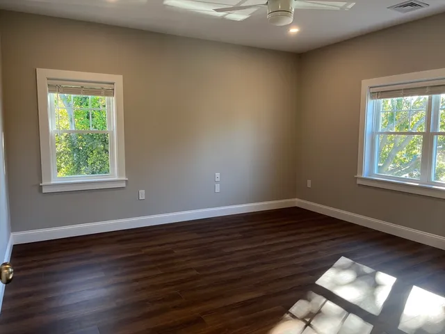 a view of balcony with wooden floor and seating space