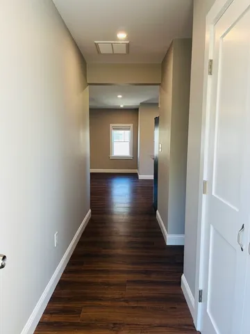 a view of front door with wooden floor