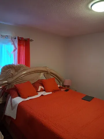 a bedroom with a bed and window