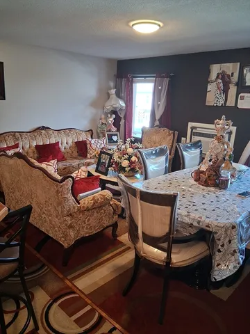 a living room with furniture and a lamp