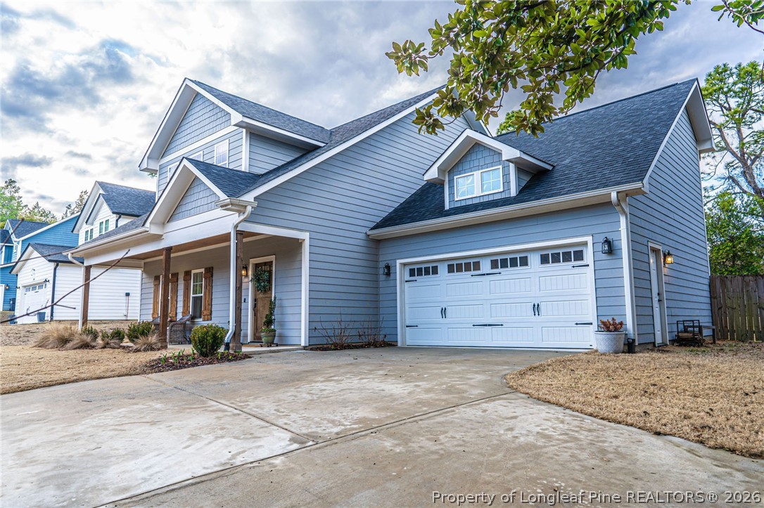 480 Clark Street Southern Pines, NC 28387 - Photo 2 of 28 a view of a house with a yard and garage