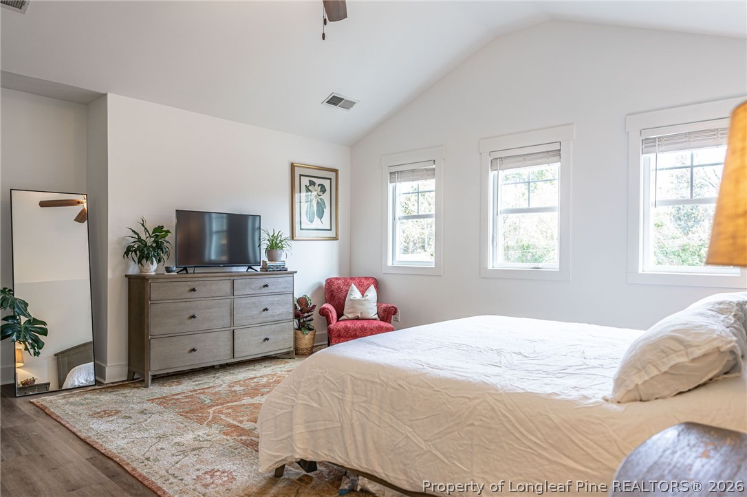 480 Clark Street Southern Pines, NC 28387 - Photo 21 of 28 a bedroom with a bed and flat screen tv