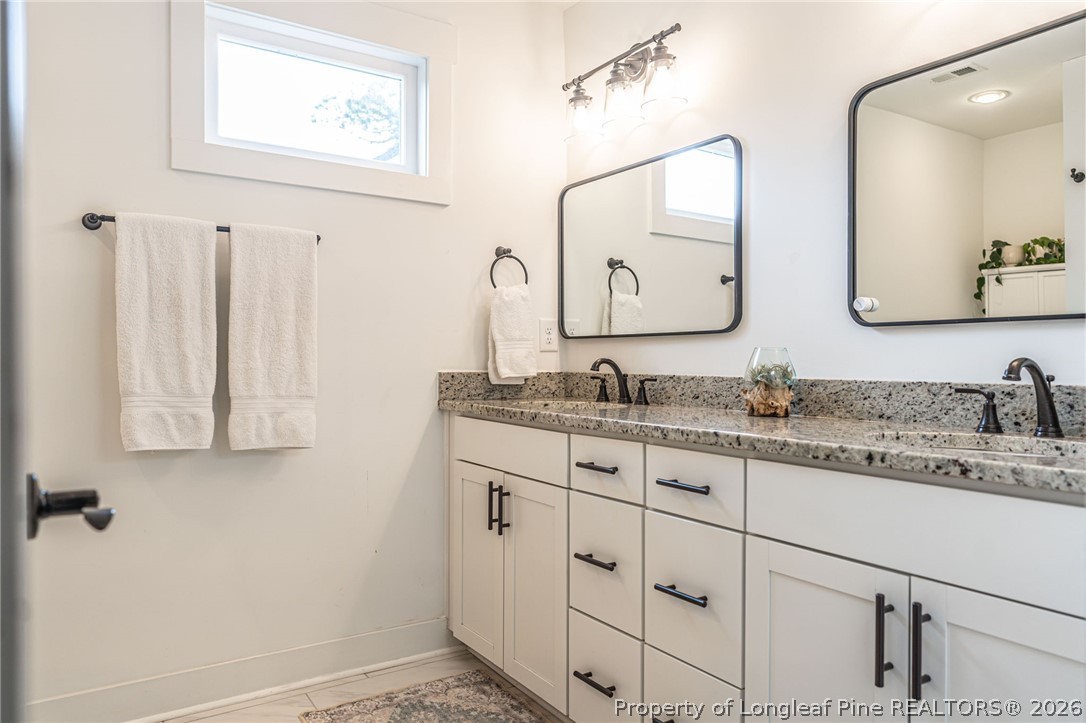 480 Clark Street Southern Pines, NC 28387 - Photo 22 of 28 a bathroom with double sink and a mirror
