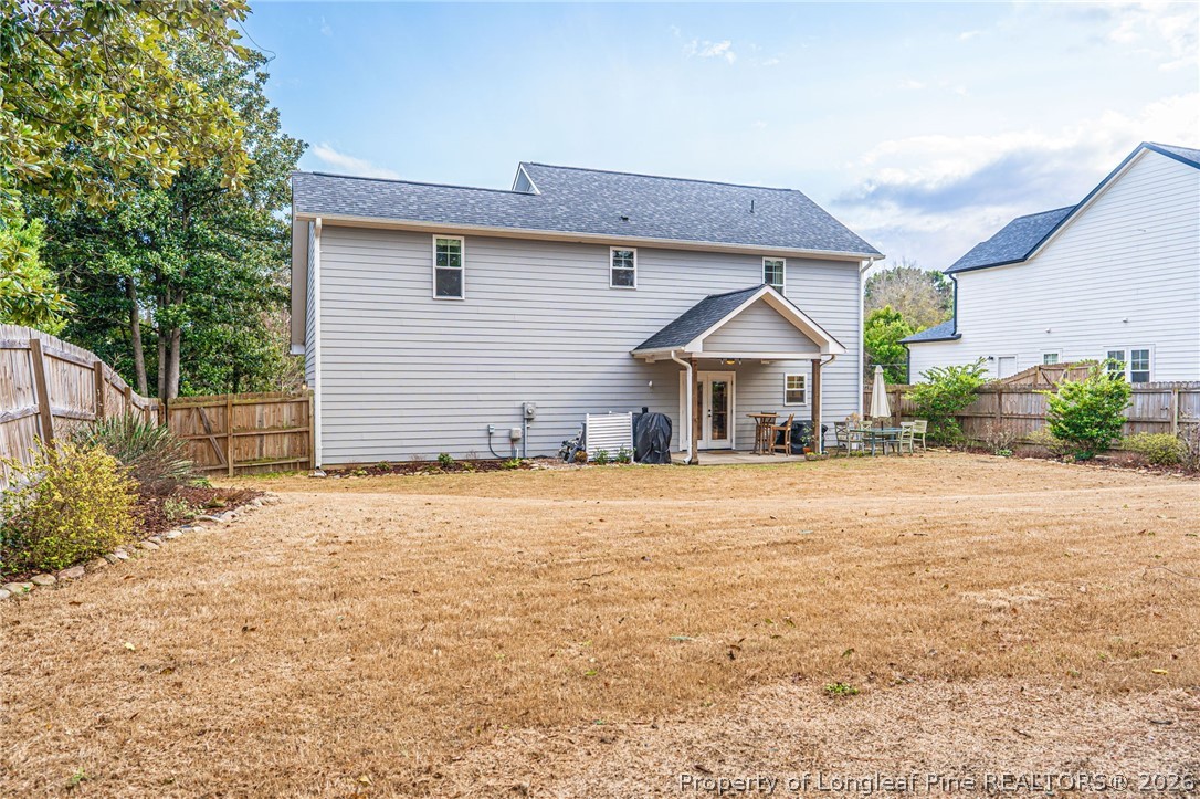 480 Clark Street Southern Pines, NC 28387 - Photo 26 of 28 a front view of house with yard and trees in the background