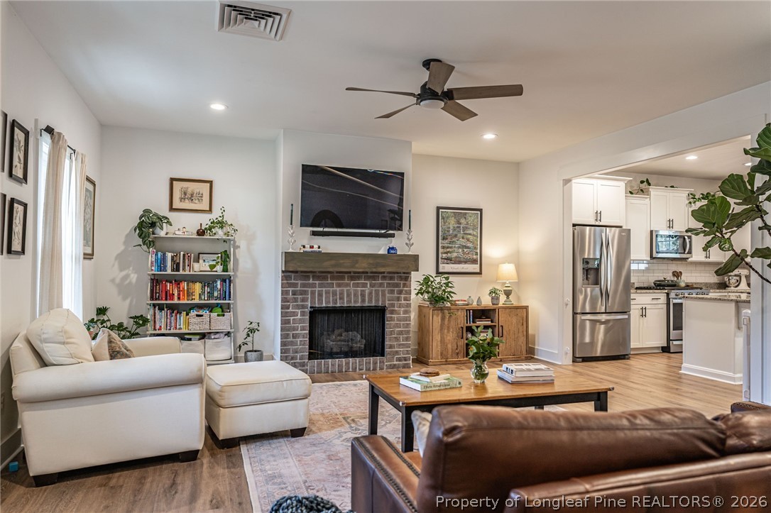 480 Clark Street Southern Pines, NC 28387 - Photo 6 of 28 a living room with furniture and a fireplace
