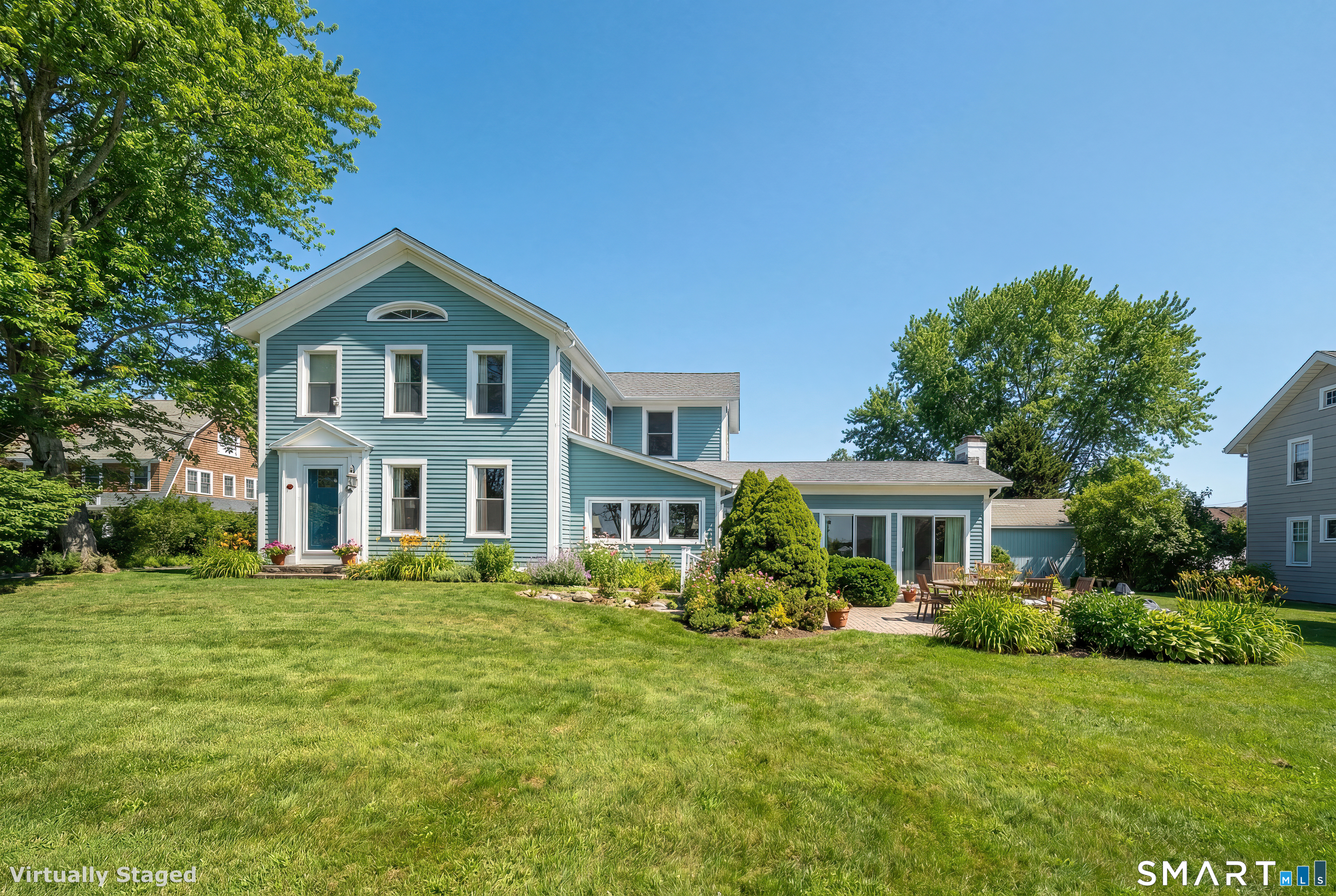 a front view of a house with a garden