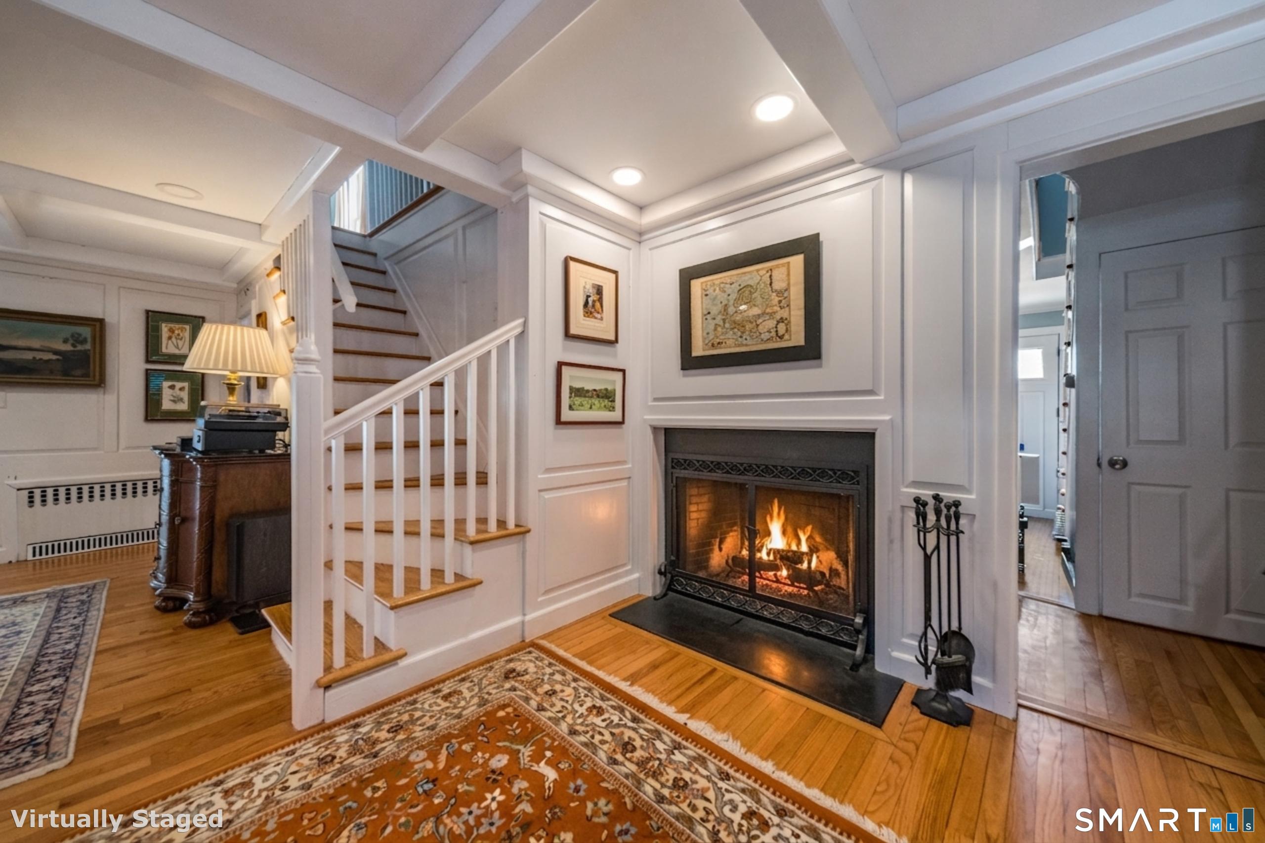 121 Middle Beach Road Madison, CT 06443 - Photo 11 of 21 a view of an entryway with wooden floor fire place and windows