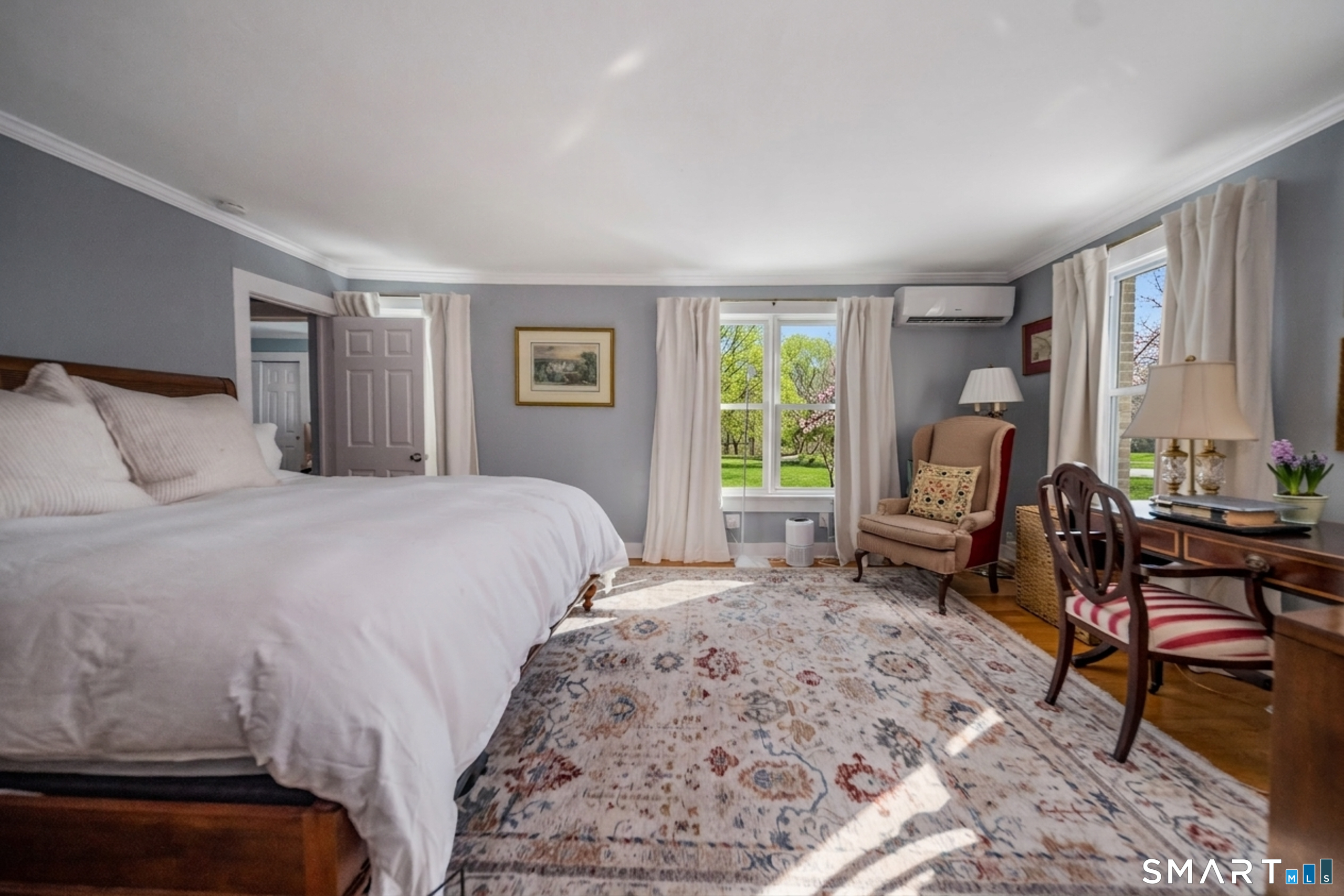 121 Middle Beach Road Madison, CT 06443 - Photo 18 of 21 a bedroom with a bed a table chair and a window