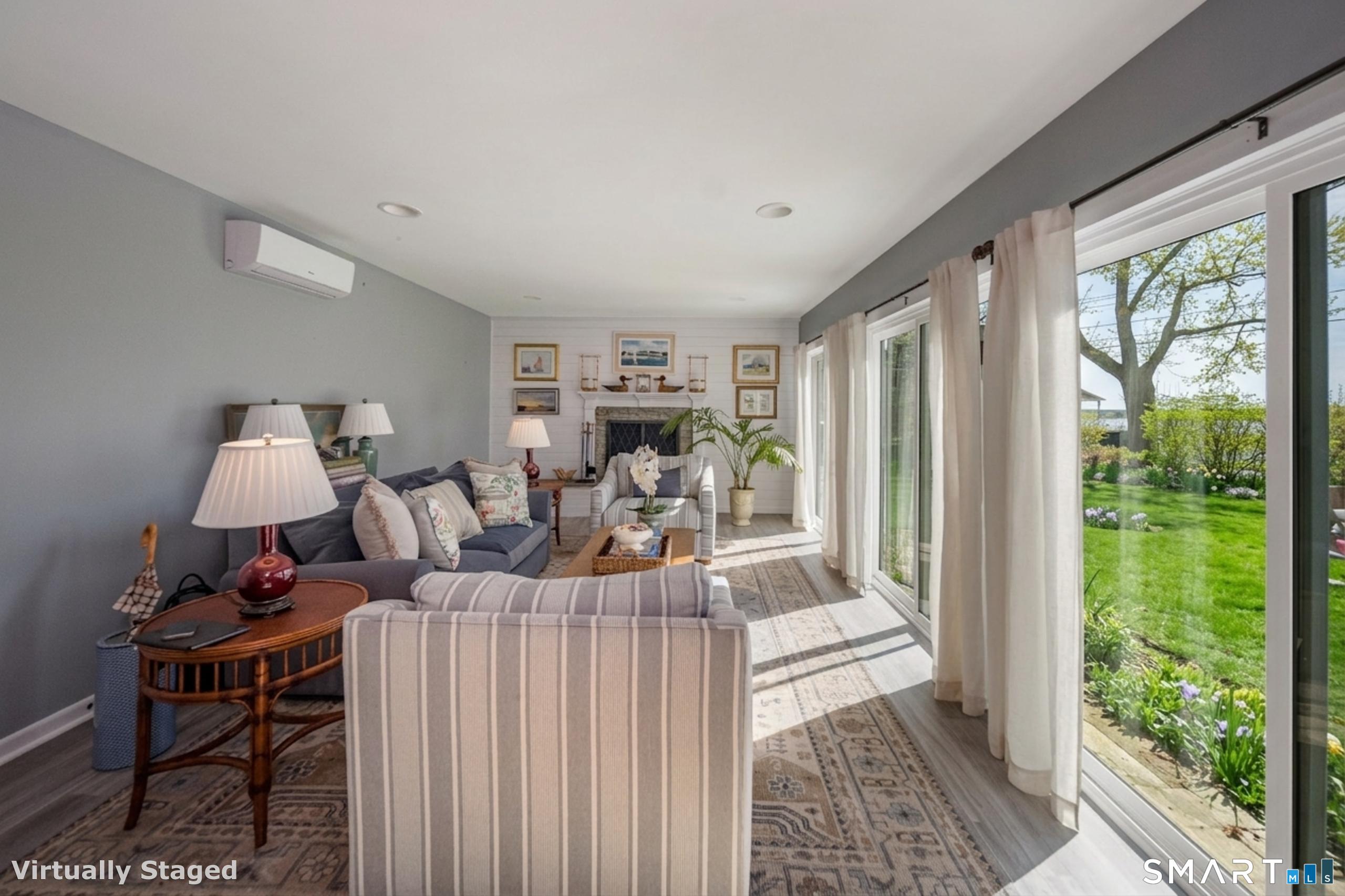 121 Middle Beach Road Madison, CT 06443 - Photo 5 of 21 a living room with furniture and a large window