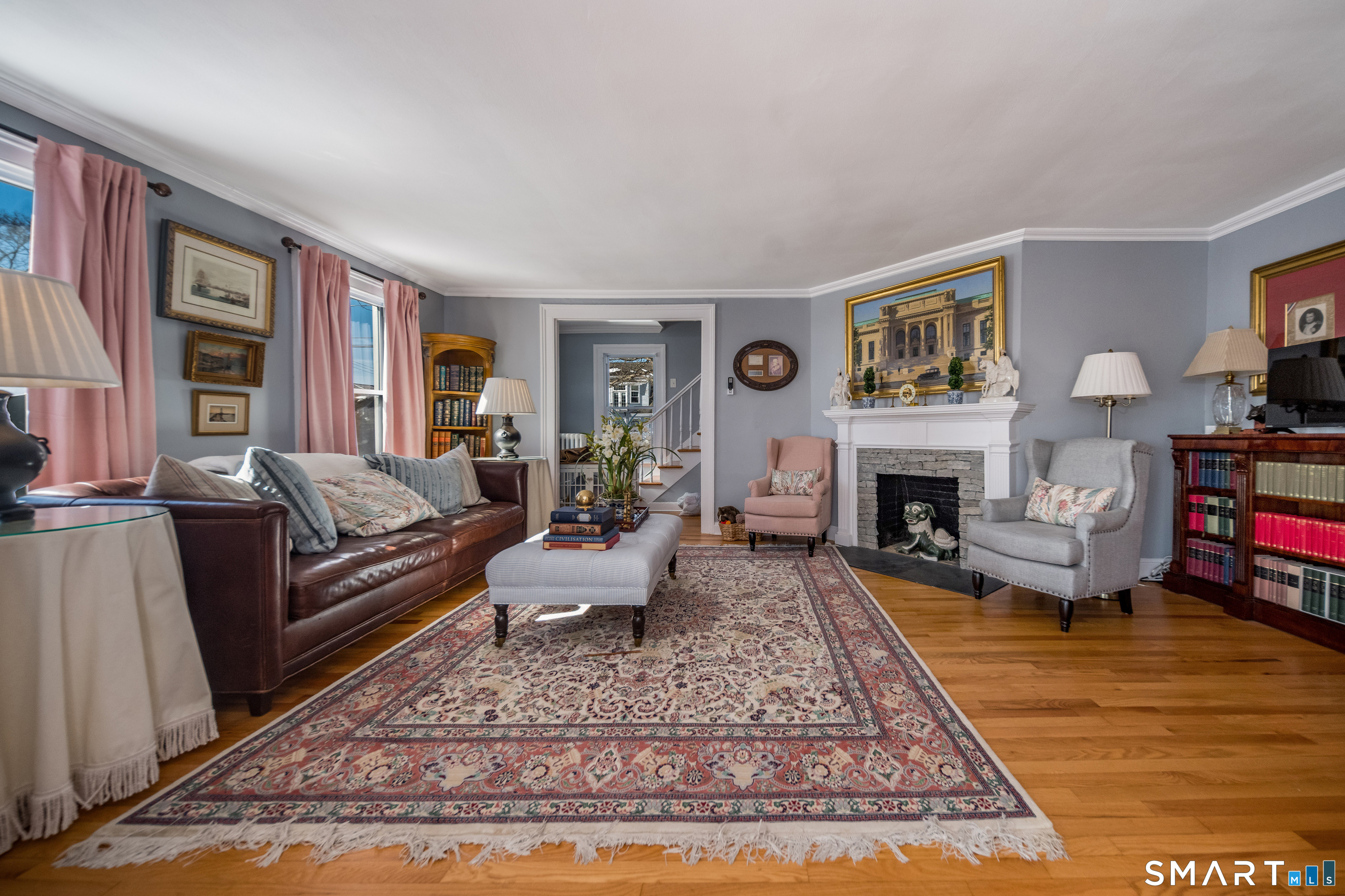 121 Middle Beach Road Madison, CT 06443 - Photo 8 of 21 a living room with furniture and a fireplace